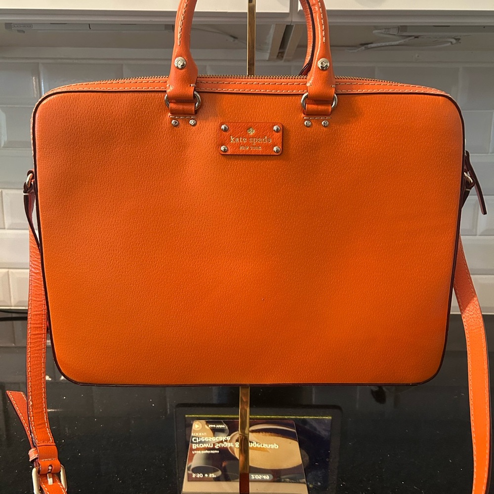 NWOT Kate Spade Orange Leather laptop bag.  May be worn crossbody.  MSRP $230